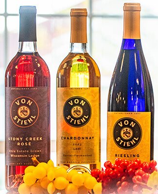 Three bottles of craft wines on a tasting bar at von Stiehl Winery.